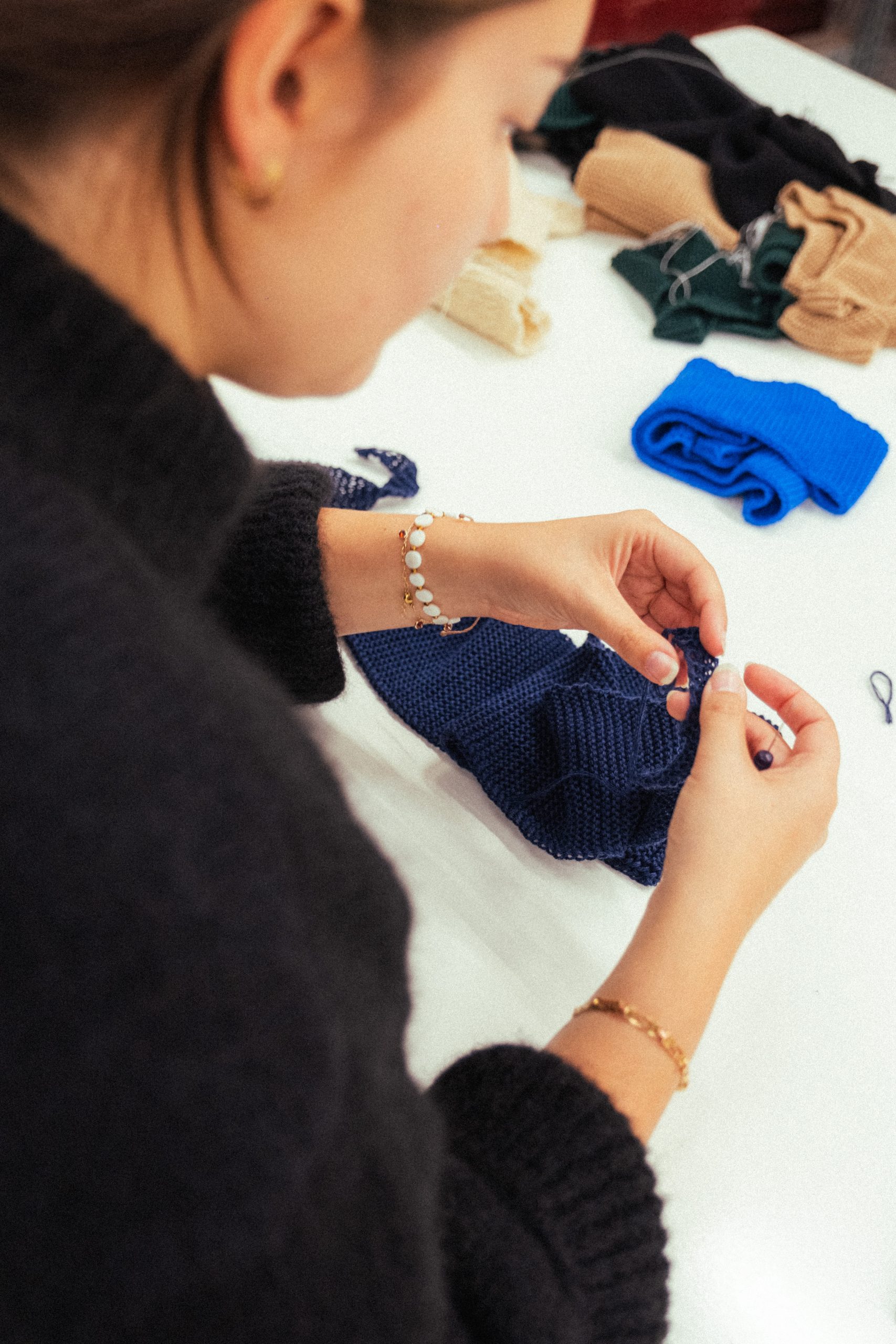 Finition par Sarah de l'équipe produits Les Trois Tricoteurs du produit le foulard en laine merinos made in France dans notre atelier de Roubaix